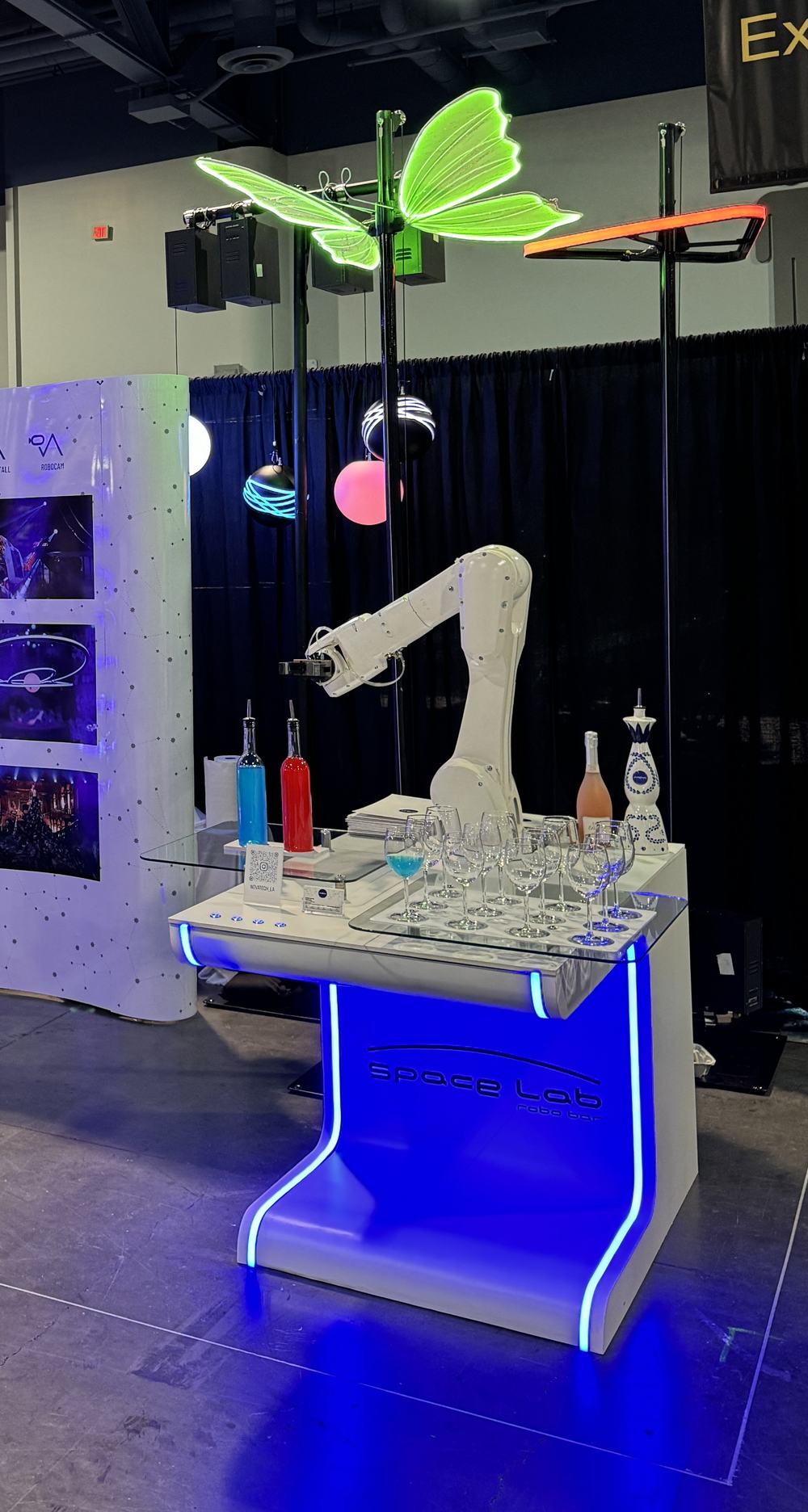 Glowing space Lab RoboBar counter with glassware under kinetic light spheres