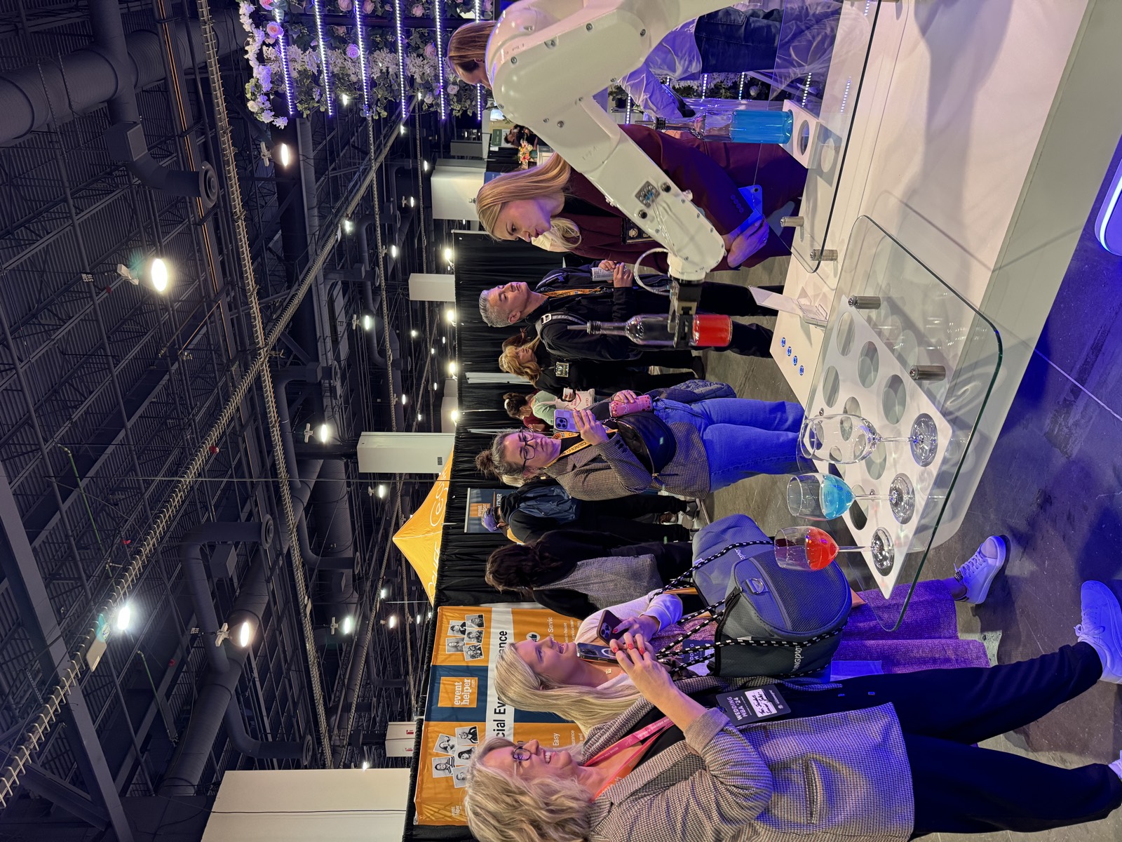 RoboBar robotic bartender pouring a red cocktail at the Wedding MBA expo