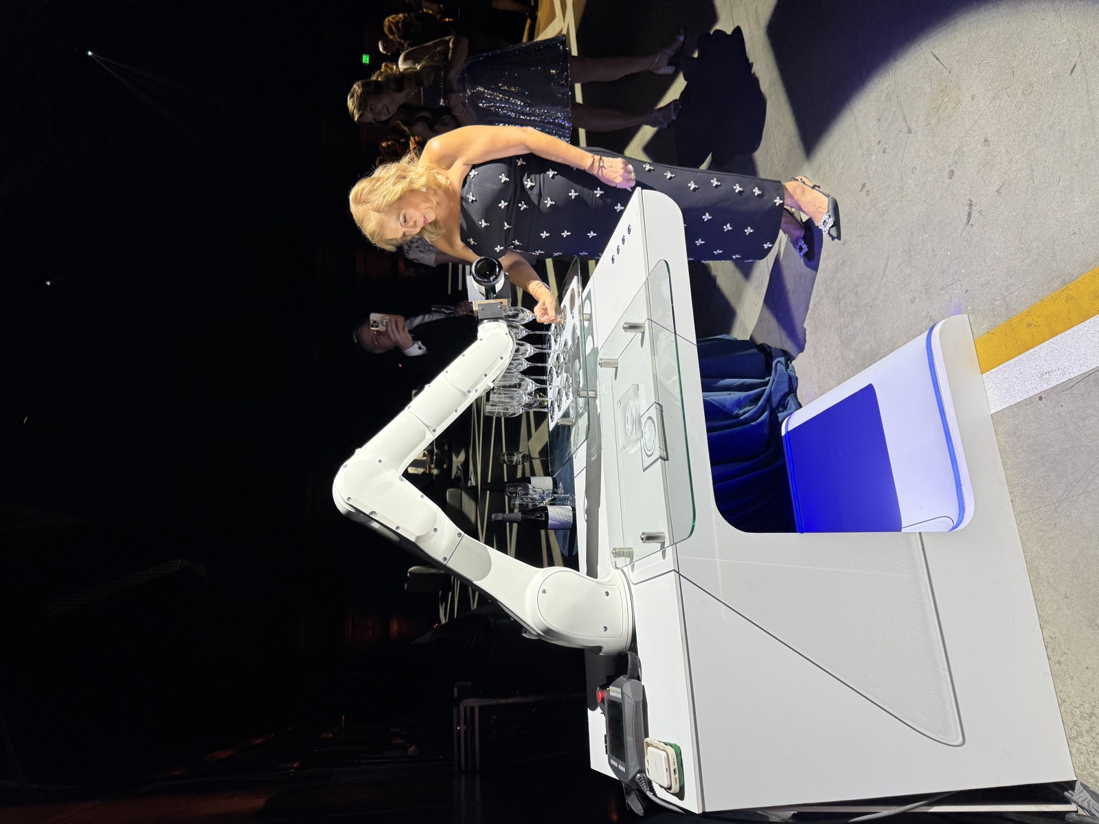 RoboBar robotic bartender serving a guest at an evening gala in Los Angeles