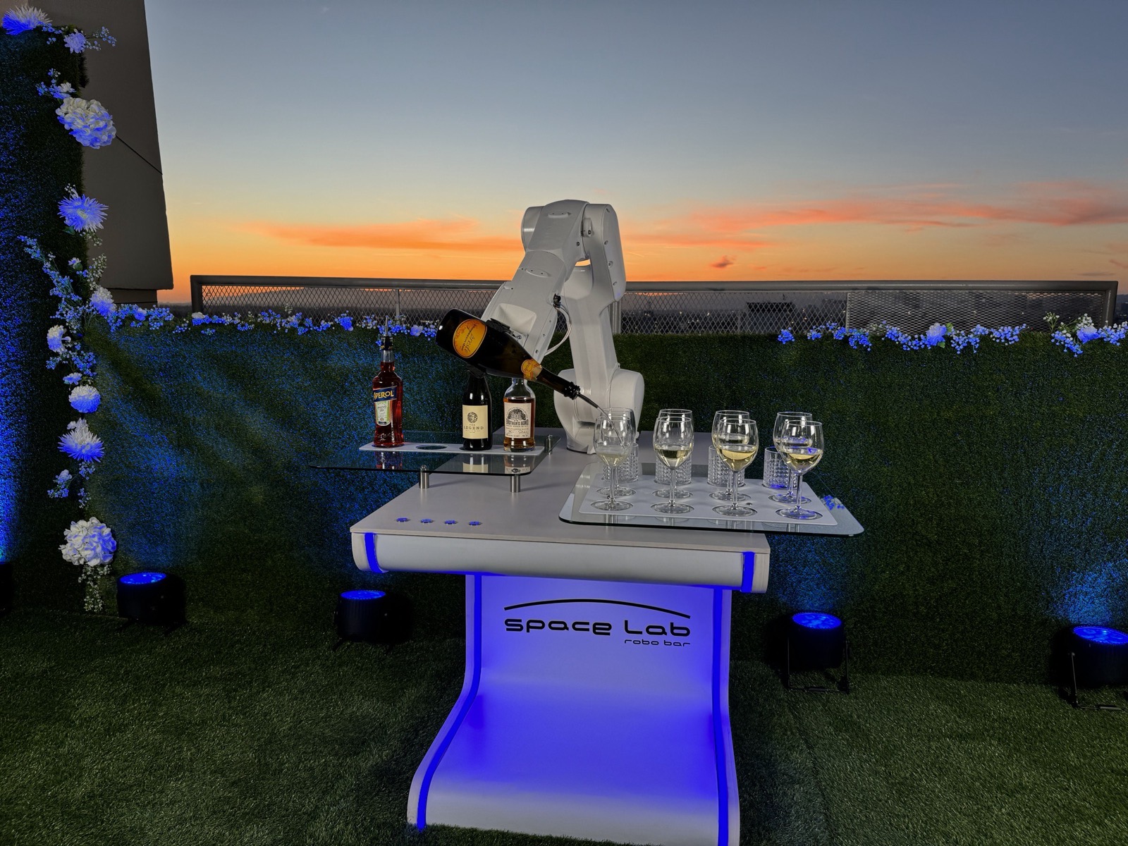 RoboBar robotic bartender pouring a drink on a sunset terrace at a California event