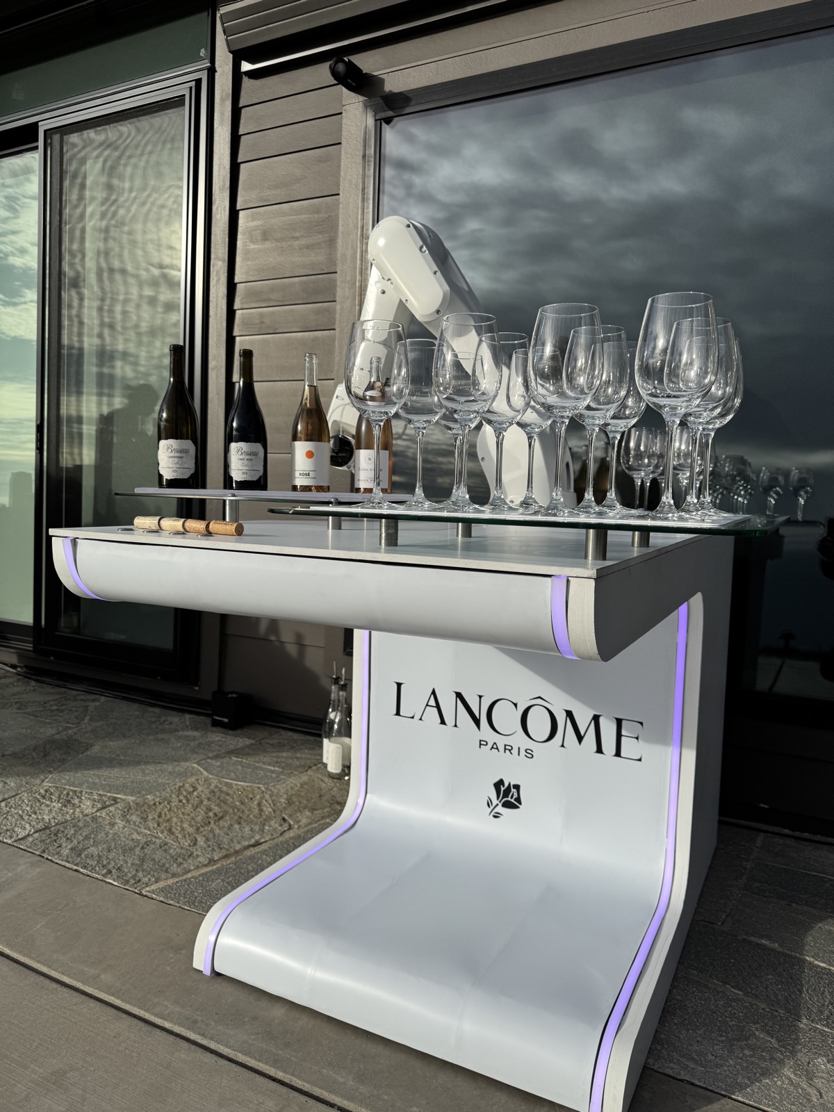 RoboBar robotic bar fully wrapped in Lancôme Paris branding with wine glasses staged for an influencer event in Big Sur